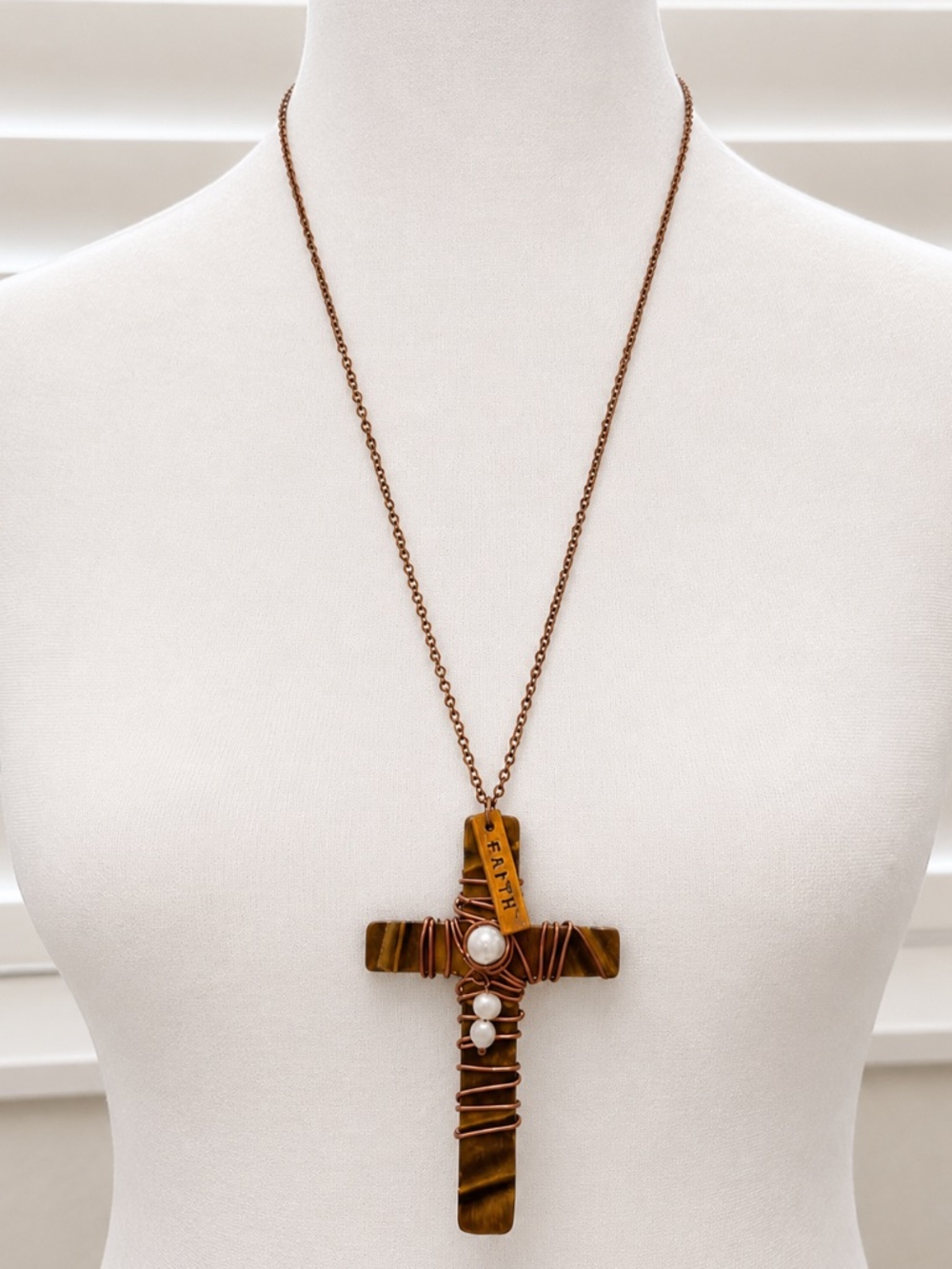 Cross pendant necklace with wire wrapping, pearl accents, and a "Faith" charm